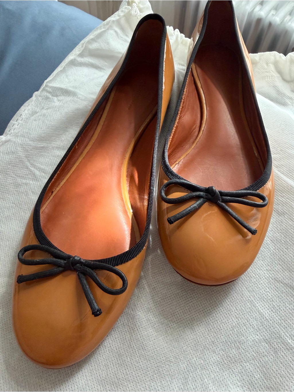 Cline Tan Ballet Flats With Black Trim And Bow Accent